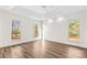 Empty primary bedroom featuring a tray ceiling, natural light from many windows, and hardwood floors at 620 St Lukes Church Rd, Salisbury, NC 28146