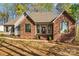 Charming brick home featuring a welcoming front porch, columns, and a landscaped walkway at 620 St Lukes Church Rd, Salisbury, NC 28146
