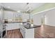 Bright kitchen with granite countertops, ample white cabinetry, and a large window over the sink at 620 St Lukes Church Rd, Salisbury, NC 28146