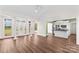 Bright living room with wood floors, white trim, and an open doorway to the kitchen at 620 St Lukes Church Rd, Salisbury, NC 28146