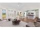 Bright living room with wood floors, white trim, and an open doorway to the kitchen with island seating at 620 St Lukes Church Rd, Salisbury, NC 28146