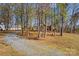 Sprawling property showcasing a home with brick accents, a long driveway, and mature trees for privacy at 620 St Lukes Church Rd, Salisbury, NC 28146