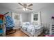 Bright bedroom features a ceiling fan, hardwood floors, and sunny windows with hanging chair at 706 Annieline Dr, Shelby, NC 28152