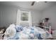 Cozy bedroom showcasing a double bed with patterned quilt and soft pillows near a vanity table at 706 Annieline Dr, Shelby, NC 28152