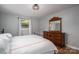 Cozy bedroom with a wooden dresser, comfortable bed, and natural light from the window at 706 Annieline Dr, Shelby, NC 28152
