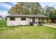 Charming single-story home featuring a well-manicured lawn, covered parking, and brick accents at 706 Annieline Dr, Shelby, NC 28152