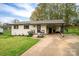 Cozy one-story home with a concrete driveway, inviting front porch, and charming curb appeal at 706 Annieline Dr, Shelby, NC 28152