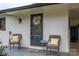 Welcoming front porch with wicker chairs, decorative wreath, and attractive brick accents at 706 Annieline Dr, Shelby, NC 28152