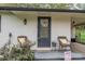 Charming front porch featuring comfortable wicker chairs, attractive wreath, and painted brick at 706 Annieline Dr, Shelby, NC 28152