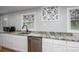 Modern kitchen featuring granite countertops, stainless steel dishwasher, and stylish windows with decorative curtains at 706 Annieline Dr, Shelby, NC 28152