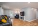 Inviting living room featuring hardwood flooring, dark leather seating, and a decorative fireplace at 706 Annieline Dr, Shelby, NC 28152