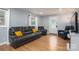 Inviting living room with a comfortable leather sofa, wood flooring, and natural light from the windows at 706 Annieline Dr, Shelby, NC 28152