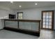 Basement bar with wood trim and corrugated metal, window and neutral tones at 923 Wyke Rd, Shelby, NC 28150
