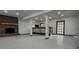 Basement with brick fireplace, bar area, neutral color palette, and door at 923 Wyke Rd, Shelby, NC 28150