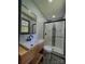 Bathroom showcasing modern vanity, black accents, and tiled shower with glass door at 923 Wyke Rd, Shelby, NC 28150