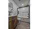 Bathroom highlighting wooden vanity, black hardware, and tiled shower-tub combo at 923 Wyke Rd, Shelby, NC 28150