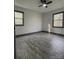 Bedroom featuring wood-look floors, light-colored walls, and windows overlooking wooded area at 923 Wyke Rd, Shelby, NC 28150