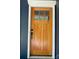 Close-up of a solid wood front door with a glass pane and classic black hardware, set in a white frame at 923 Wyke Rd, Shelby, NC 28150