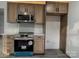 Kitchen area with stainless steel appliances, shaker cabinets, and a geometric tile backsplash at 923 Wyke Rd, Shelby, NC 28150