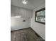 Laundry room featuring gray floors, white cabinets and a window looking out to the greenery at 923 Wyke Rd, Shelby, NC 28150