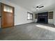 Spacious living room with modern gray floors, a cozy brick fireplace, and ample natural light through a window at 923 Wyke Rd, Shelby, NC 28150
