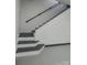 Gray staircase with black handrail and white risers leading to upper level at 923 Wyke Rd, Shelby, NC 28150