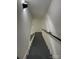 Staircase featuring neutral walls and gray steps with a black handrail at 923 Wyke Rd, Shelby, NC 28150