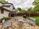 Backyard features include a tiled patio, a grill, an outdoor shed, string lights, and seating at 925 E 35Th St, Charlotte, NC 28205