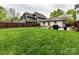 Large, well-manicured backyard featuring a stone patio and outdoor dining area at 925 E 35Th St, Charlotte, NC 28205