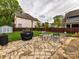 Backyard features include a tiled patio, a grill, an outdoor shed, string lights, and seating at 925 E 35Th St, Charlotte, NC 28205