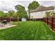 Well-maintained backyard with lush green grass, a privacy fence, storage shed, and patio at 925 E 35Th St, Charlotte, NC 28205