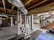 Unfinished basement offering potential with exposed beams and brick support pillars at 925 E 35Th St, Charlotte, NC 28205