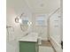 This bathroom features tile flooring, a shower-tub combination, a white toilet, and a green vanity at 925 E 35Th St, Charlotte, NC 28205