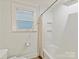 This bathroom features tile flooring, a shower-tub combination, a white toilet, and subway tiling at 925 E 35Th St, Charlotte, NC 28205
