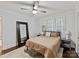 This bedroom features a ceiling fan, an area rug, and large windows with natural light at 925 E 35Th St, Charlotte, NC 28205