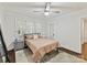 This bedroom features a ceiling fan, an area rug, and large windows with natural light at 925 E 35Th St, Charlotte, NC 28205