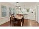 Open dining area adjacent to a modern kitchen, featuring hardwood floors and lots of natural light at 925 E 35Th St, Charlotte, NC 28205