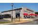 Heist Brewery featuring a modern exterior and inviting outdoor seating area with red umbrellas at 925 E 35Th St, Charlotte, NC 28205