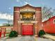 Historic brick fire station with a bright red garage door and classic architectural details at 925 E 35Th St, Charlotte, NC 28205