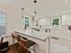 Bright kitchen features white cabinets, a marble countertop island with seating, and stainless steel appliances at 925 E 35Th St, Charlotte, NC 28205