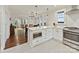 Bright eat-in kitchen with white cabinets, stainless appliances, and eat-in area overlooking the living room at 925 E 35Th St, Charlotte, NC 28205