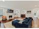 Spacious living room featuring a cozy fireplace, hardwood floors, and a comfortable blue couch at 925 E 35Th St, Charlotte, NC 28205