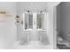 Modern bathroom with dual pedestal sinks, bright lighting, and a separate toilet room at 925 Westmere Ave, Charlotte, NC 28208