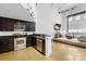 Modern kitchen featuring stainless appliances, dark cabinets, and an island with bar seating at 925 Westmere Ave, Charlotte, NC 28208