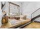 Inviting living room with exposed brick, tall windows, and modern industrial design at 925 Westmere Ave, Charlotte, NC 28208