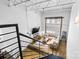 Lofted living room with industrial style, cozy seating, and abundant natural light at 925 Westmere Ave, Charlotte, NC 28208
