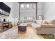 Stylish living room offering comfortable seating, high ceilings, and lots of natural light at 925 Westmere Ave, Charlotte, NC 28208