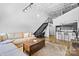 Open living space with exposed beams, metal staircase, and a modern kitchen backdrop at 925 Westmere Ave, Charlotte, NC 28208