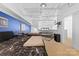 Spacious living room with exposed ceilings, couch, and a bedroom area, perfect for modern living at 925 Westmere Ave, Charlotte, NC 28208