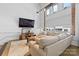 Cozy living room featuring a plush sectional, modern entertainment center, and window details at 925 Westmere Ave, Charlotte, NC 28208